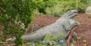 The stone sculpture of an iguanadon looks like an oversized modern-day iguana, and nothing at all like the tall, relatively lean therapod we know today.