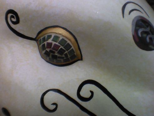 Regal Rabbit's eye is made of a mosaic of dark red and green stones. 