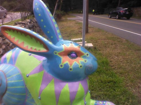 OtherSide Even Jester's ears are festive, with bright orange triangles framing a pale green inner ear. Along the back of the other ear (painted blue) we can see green polka dots.