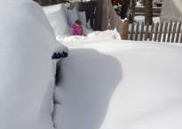 My daughter stands in the snow along the side of our driveway. The drifts are impressive, completely encasing our cars, but it is the fact that the snow on the ground (not drifts) is as deep as she is tall that catches my eye.