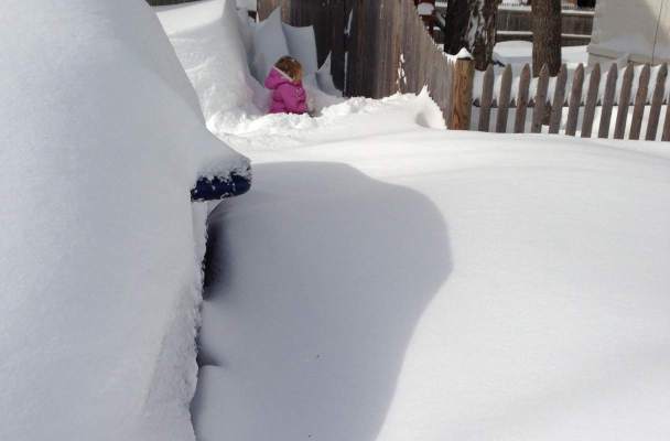 My daughter stands in the snow along the side of our driveway. The drifts are impressive, completely encasing our cars, but it is the fact that the snow on the ground (not drifts) is as deep as she is tall that catches my eye.