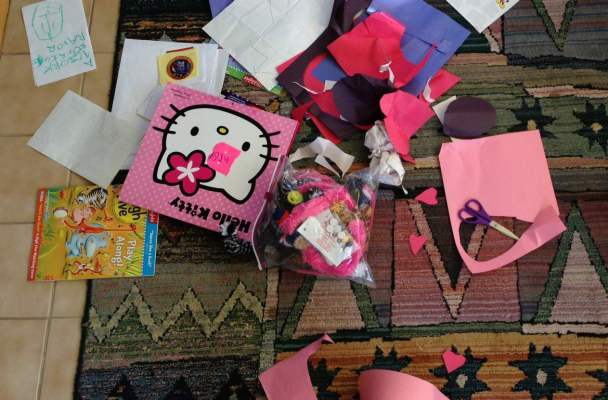 Papers and toys scattered on a rug.