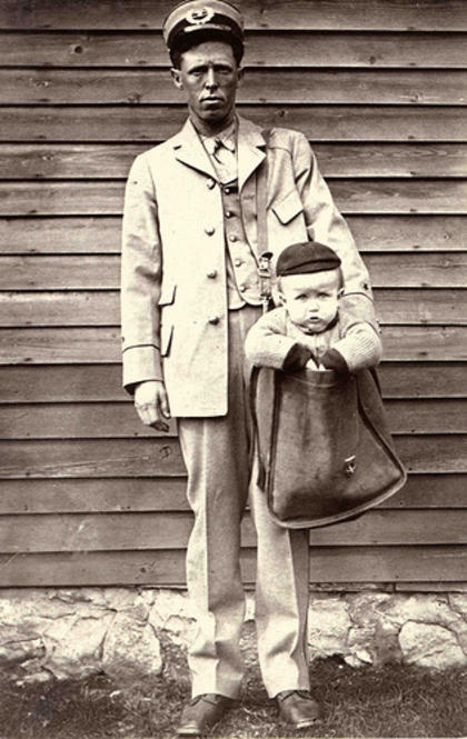 A mail carrier poses with a child in his mailbag for a photograph illustrating the new regulations against shipping children parcel post. Although kids generally fell under the 50 lbs guideline for parcel post, the Postmaster General determined that children did not fall under the "bugs and bees" classification that limited the types of fauna that could be sent through the US mail. (Photo & background info on it via the Smithsonian's public domain Flickr stream.)