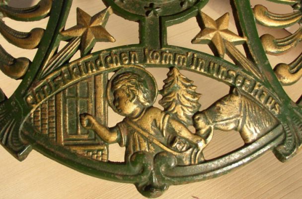 closeup of a bronze artwork showing the child Jesus