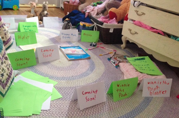 papers scattered across a bedroom floor. Some are propped up next to stuffed animals as if in a museum exhibit.