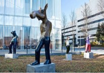 Statue of a moose standing like a man in front of Anchorage Art Museum.