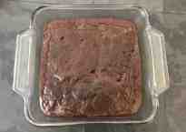 fresh baked brownies in a clear baking pan