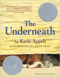 book cover for The Underneath shows a basset hound huddled with a family of cats under a wooden building