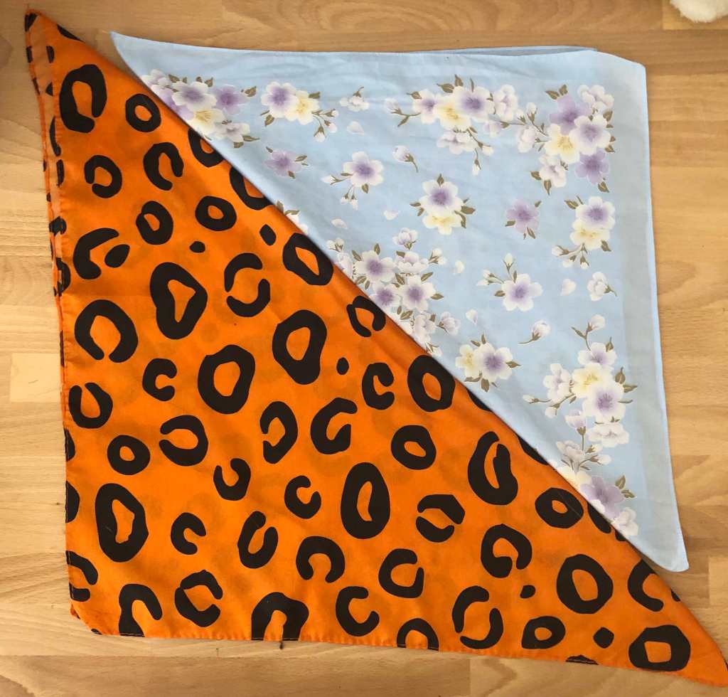 Photo shows two bandanas laid so that it's easy to see that one is much smaller than the other.