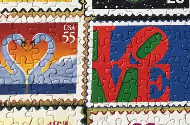 close-up of two stamps from the Love Stamp Puzzle. One shows a pair of swans in profile against a sunset (the swan's necks make a heart). The other shows the LOVE sculpture American artist Robert Indiana which has the letters L and O mounted on top of the V and E.