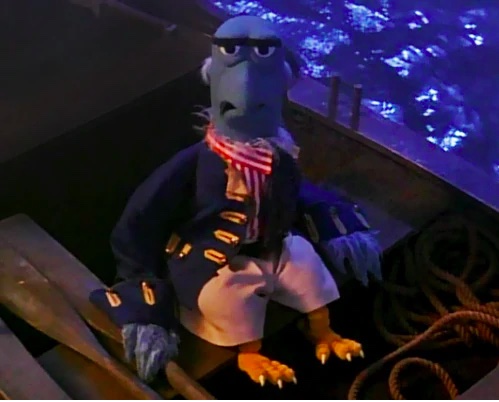 Sam the Eagle dressed as a sailor and seated in a row boat. 