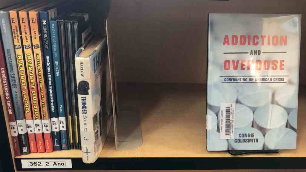 A shelf labeled 362.2 Ano in our nonfiction section. The book on display is Addiction and Overdose by Connie Goldsmith. Tucked into the shelf is Thunder from the Sea by Joan Harlow. That book belongs in the fiction section. 